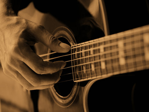 The man playing the guitar