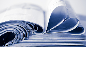stack of magazines toned blue isolated - Powered by Adobe