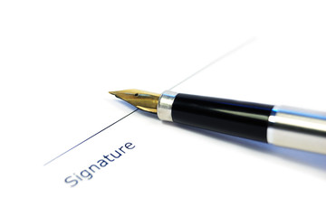 A document with a place for a signature and a gold nibbed pen