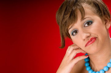 Portrait of young model with blue beads