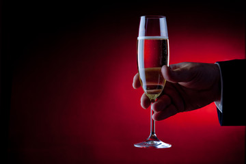 Hand holding a glass of champagne