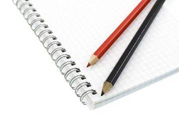 pencils on the blank spiral notepad