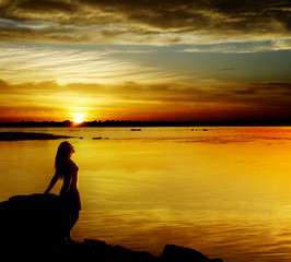 Silhouette the woman  at sunset