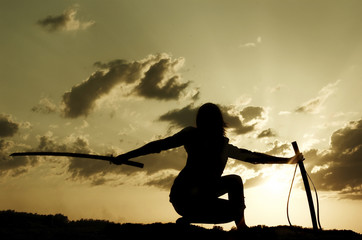 Silhouette samurai on a background sundown