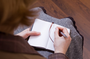 Female writes notes in notebook