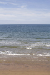 Fototapeta na wymiar Gentle waves lapping the beach