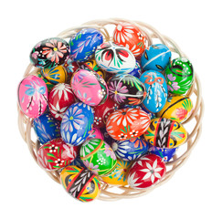 Hand made Easter eggs arranged in a wicker bowl
