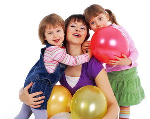 Fototapeta na wymiar Mother and his two daughters with colorful balloons.
