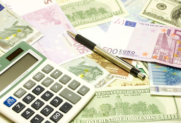 Dollar, euro, lat banknotes, calculator, pen