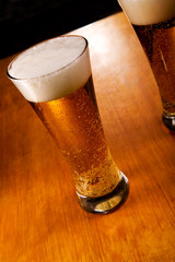 Two beer glasses, focus on first