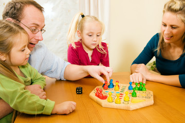 Familie spielt zusammen ein Brettspiel