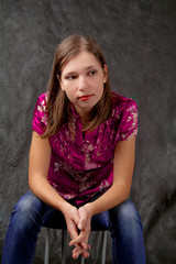 young girl sitting on chair with hands crossed appear thinking