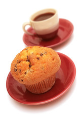 Muffin and cup of coffee isolated on white.