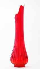 Vase with a fluted top, slender neck and a bulbous bottom.