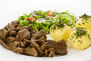 Grilled meat with boiled potatoes, sauce and vegetable salad