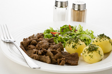 Grilled meat with boiled potatoes, sauce and vegetable salad