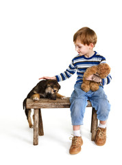 Child on bench and puppy