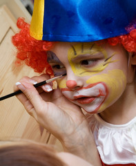 The boy wearing clown