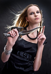 blond young girl holding dagger