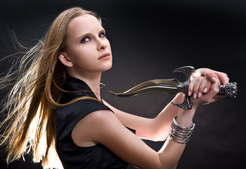 blond young girl holding dagger