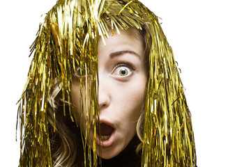 Surprised blonde in tinsel wig on white background