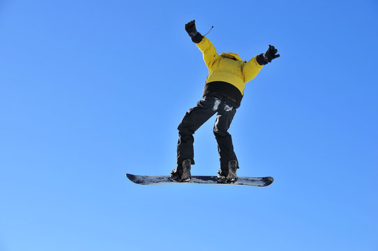 man on snowboard jumping