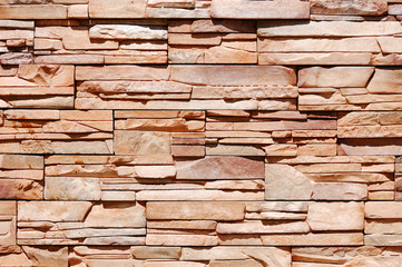 Fragment of warm colored rough brick wall