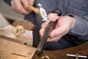 Goldsmith work in process with hammer