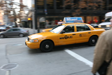 Fast driving yellow cab (Taxi car) in Manhattan Soho in New York City, USA