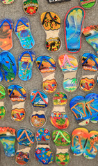 Colorful sandals in sand