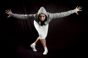 beautiful modern ballet dancer posing on black background