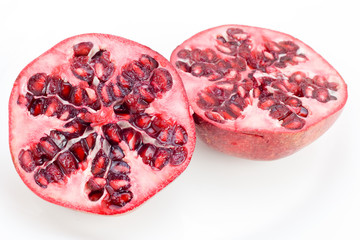 A fresh halved Pomegranate isolated on white