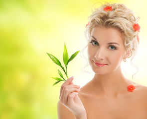 Naklejka premium Beautiful blond woman with young plant.