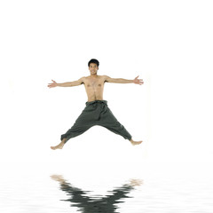 Fototapeta na wymiar Attractive Young man flying in the air. with reflection