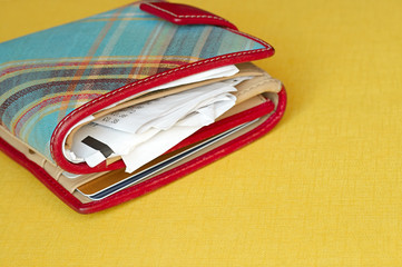 A wallet which contains some cards and lots of receipts