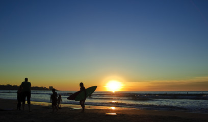 Surfers at sunset