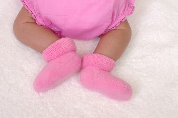 newborn baby girl's legs, three weeks old