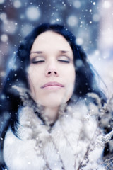 Young woman tender portrait with snow