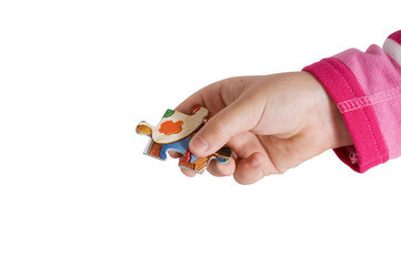 Child hand holding a piece of puzzle
