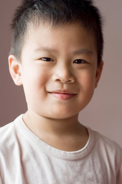 Photo of Asian young boy looking at camera