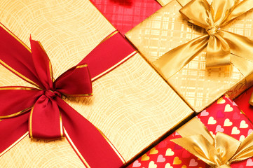 Close up of gift boxes with golden ribbons