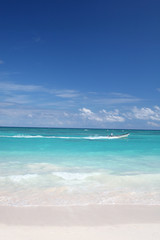 Tropical Paradise - White Sand Beach, Motor Boat in Gree Ocean