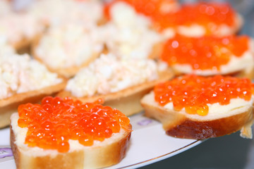Red caviar on bread with butter