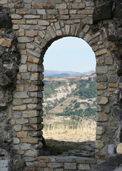 Ancient stone doorway of medieval castle ruin on hill