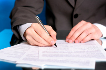 businessman writing on a form