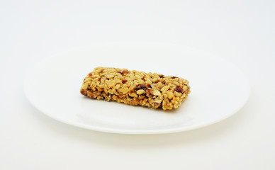 Energy bar on a white plate for a snack.