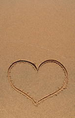Fototapeta na wymiar Heart drawing in sand, with copy-space