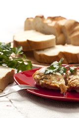 Roasted chicken in butter with bread and greenery