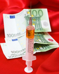 syringe and money