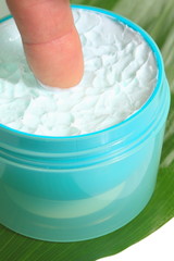 Cosmetic cream on background green leaf